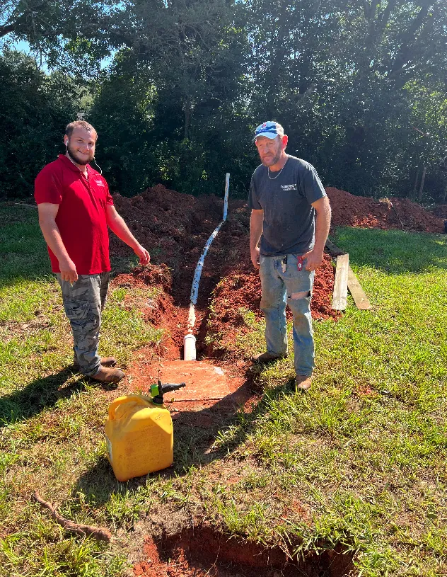 two plumbers repair in ground plumbing